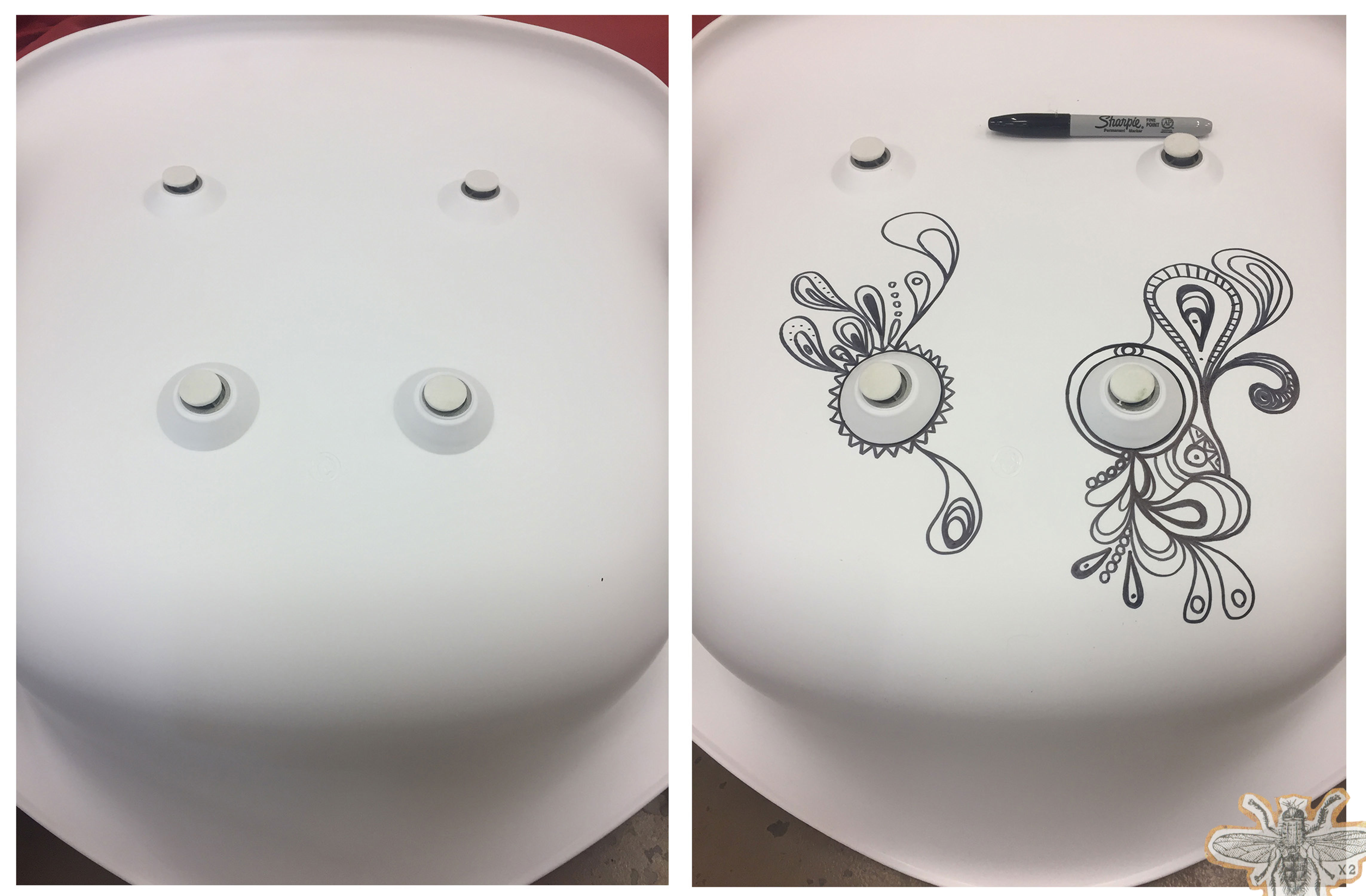 Two modern white chairs that have been decorated with Sharpie doodles.